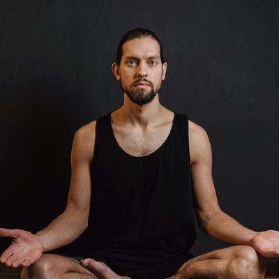 Person sitting in meditation posture calmly